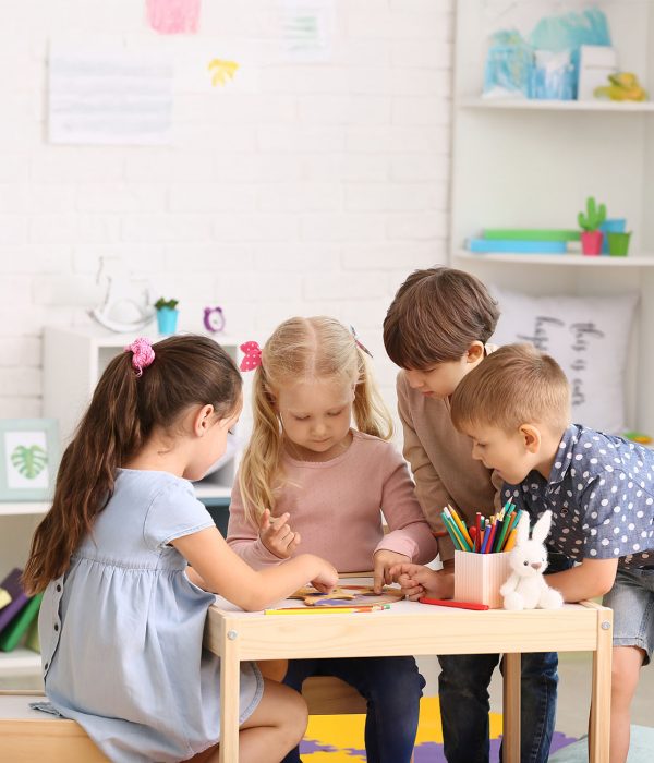 Cute little children playing in kindergarten